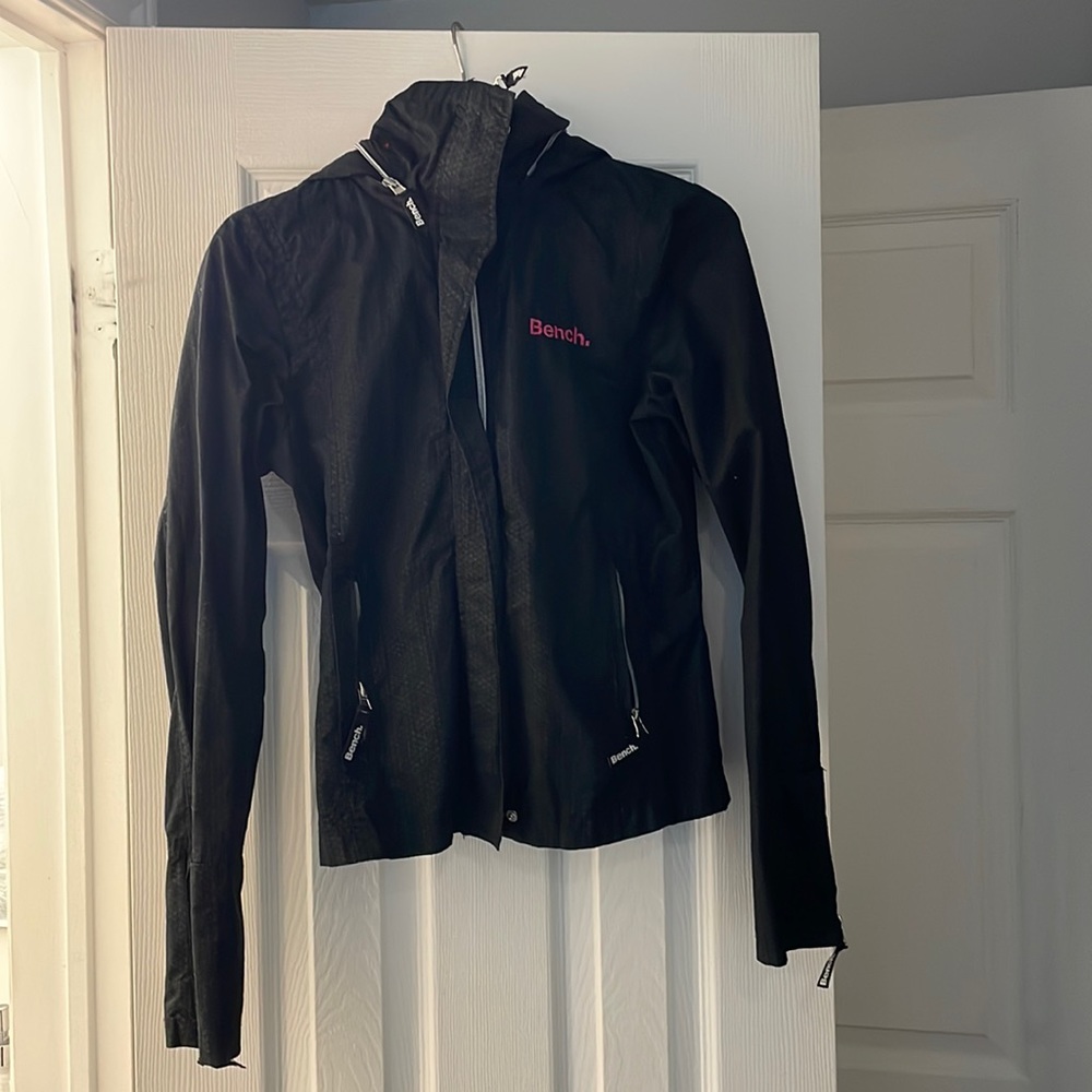 Black bench jacket with hot pink logo on collar. (Spring/fall)